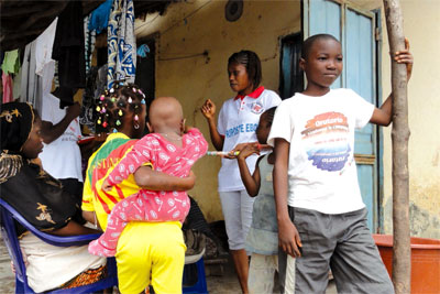 Guinea Red Cross volunteers travel door-to-door sharing information about Ebola.