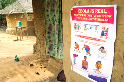 An "Ebola is Real" campaign poster in a Liberian village.
