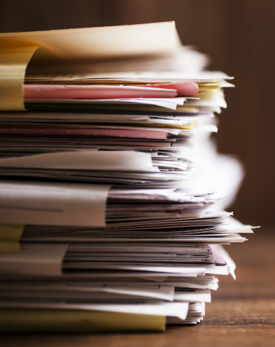 A stack of papers in folders.