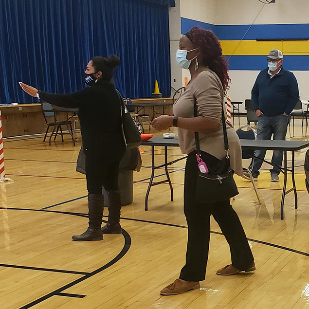 CDC’s Ada Dieke, right, assists with preparing staff to set up a safe polling location