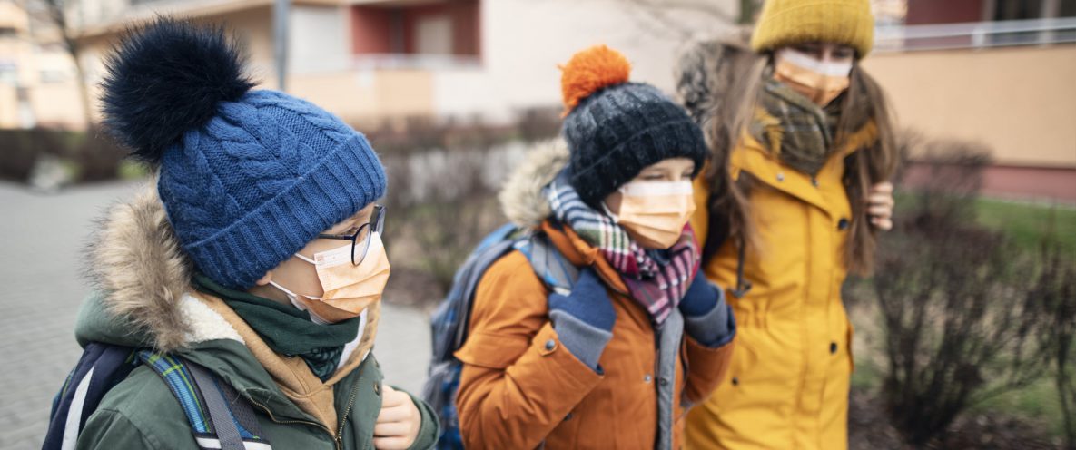 3 kids walking to school in winter