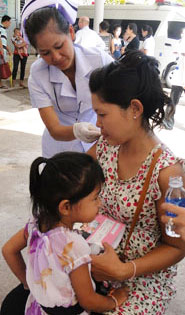 In Laos, a pregnant woman receives her seasonal flu shot.