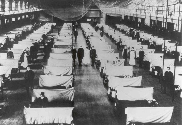 Cots set up in gymnasium for flu patients
