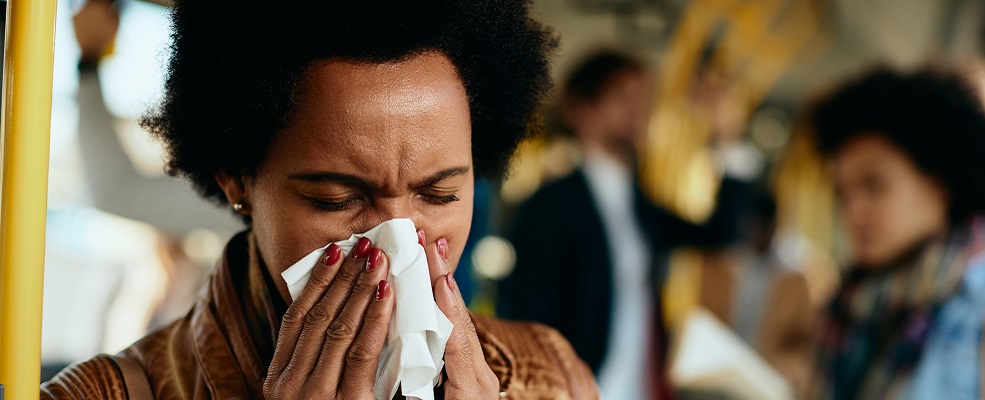 A woman blowing her nose.