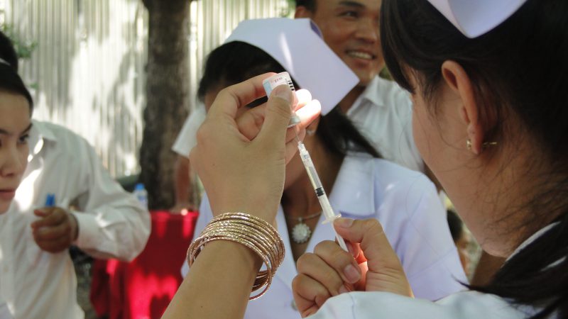 Nurse filling syringe