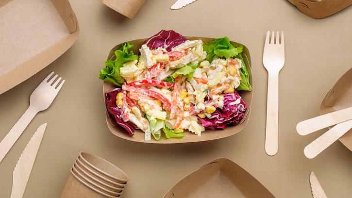 Salad with compostable bowls, flatware, and cups.