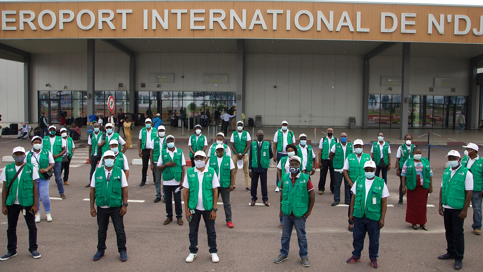 Group shot of volunteers at airport deploying to support COVID-19 response