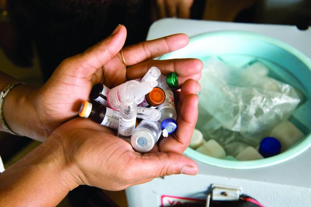 A nurse at the Lotus Colony Health Post in the Shivaji Nagar slum handles vaccines for babies