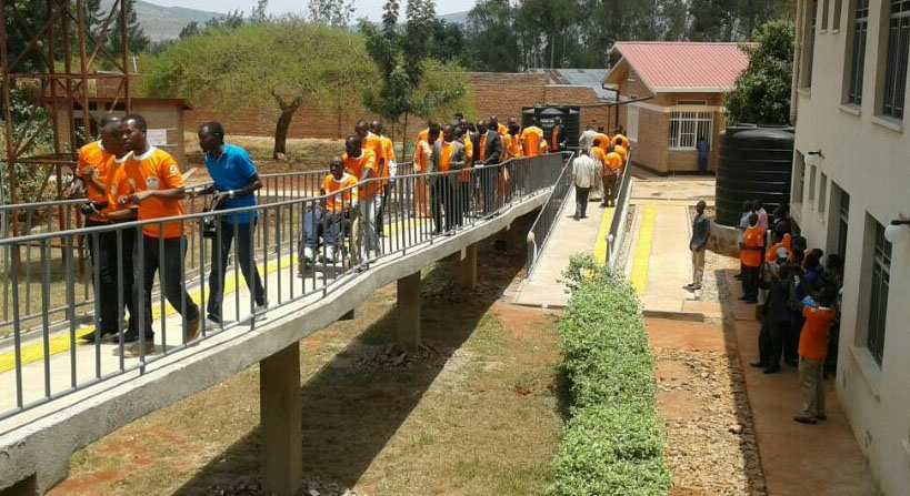 UPHLS members and partners use a newly renovated access ramp at a health facility in Rwanda. This is one of several health facilities renovated for easier access by HIV/AIDS patients with disabilities. (Photo: CDC Rwanda)