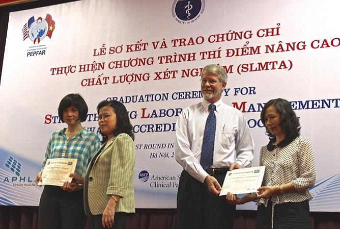 David Nelson, CDC Vietnam Deputy Director and Vice Minister of Health Nguyen thi Xuyen giving certificates for SLMTA.