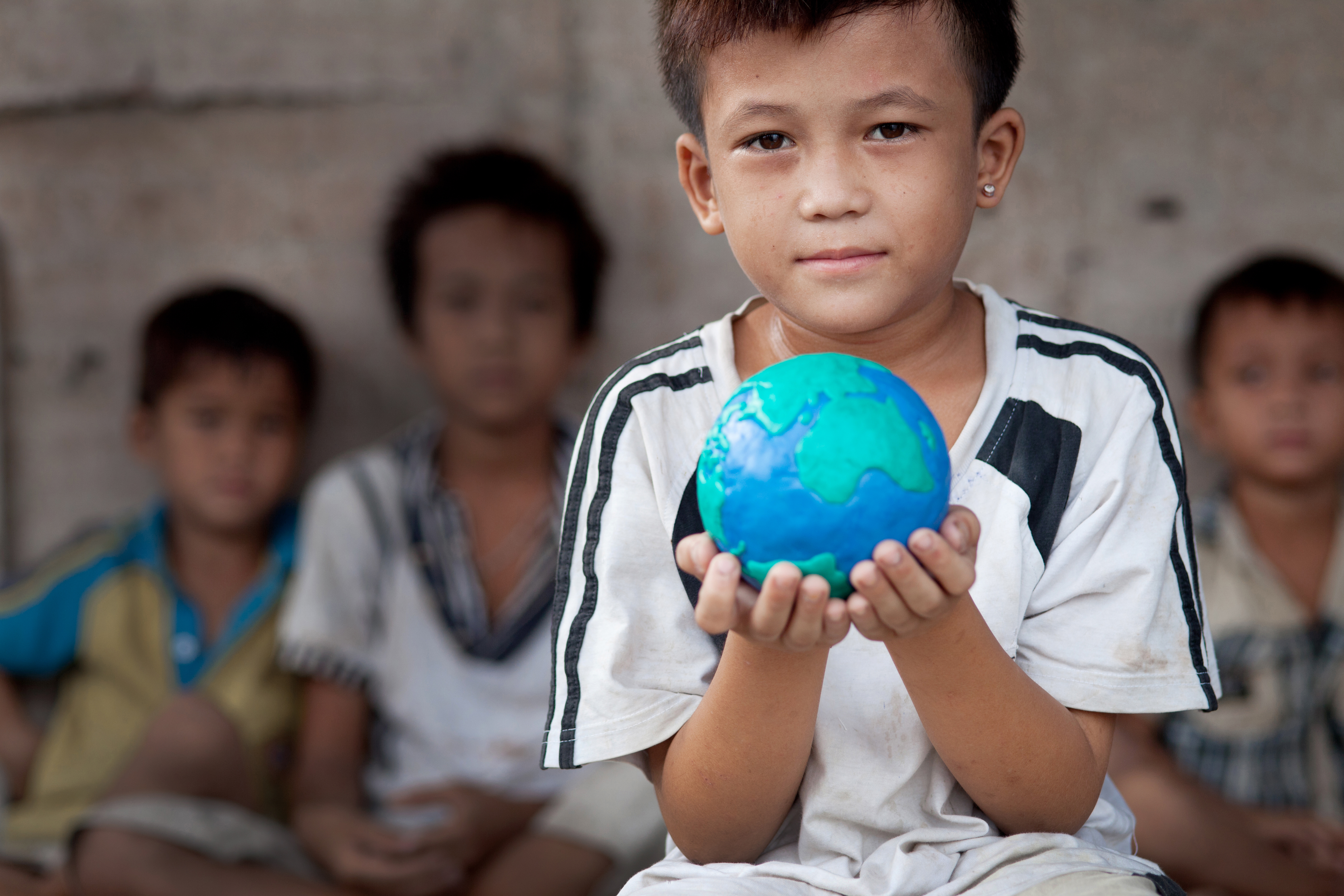 child holding world globe