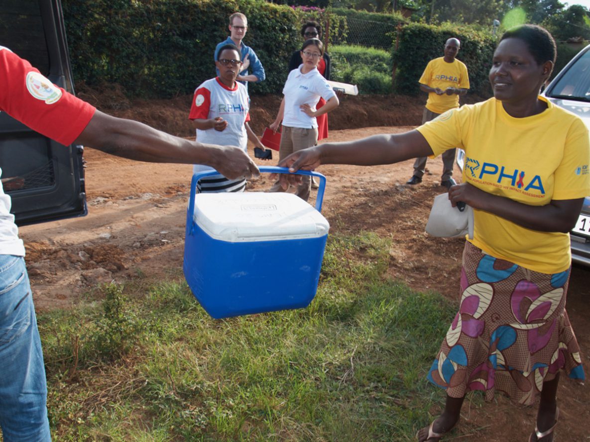 Rwanda PHIA data collector handing over blood samples to the driver to be transported to the satellite laboratory.