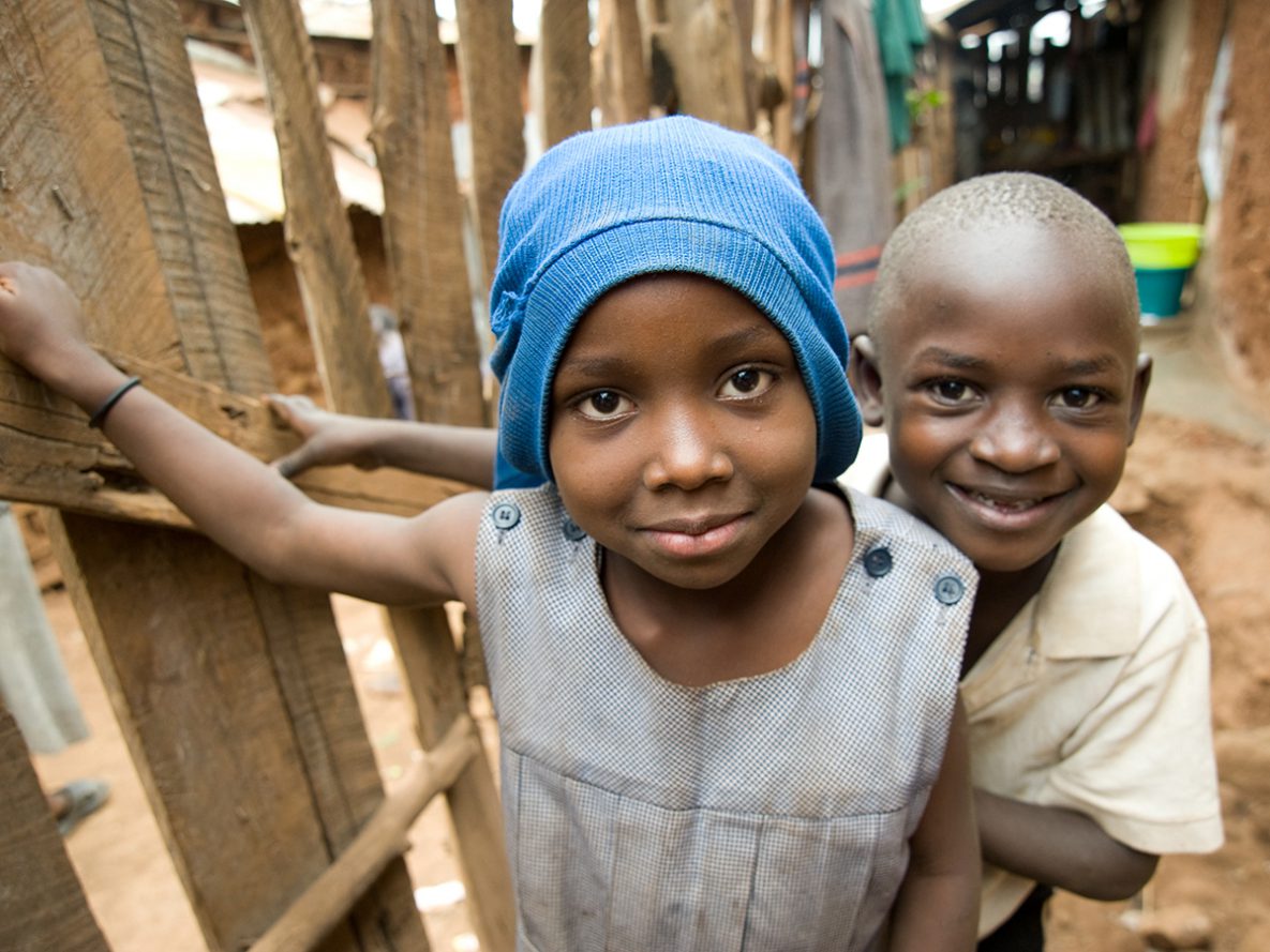 A young girl and boy outside of their family home in the Kibera informal settlement in Nairobi, Kenya.