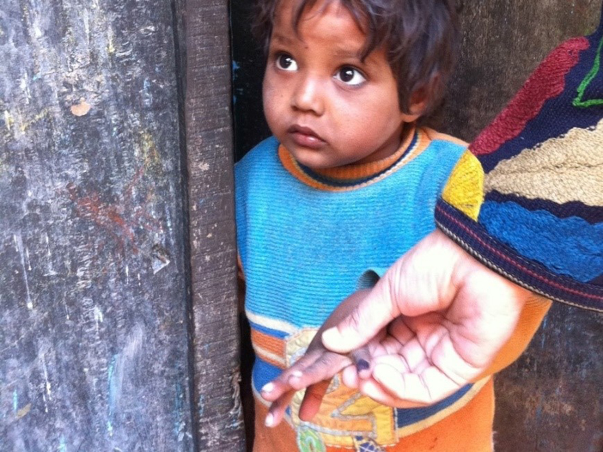 Vaccinators mark the pinkies of children who received their polio vaccine with purple markers to keep track of whose been vaccinated.