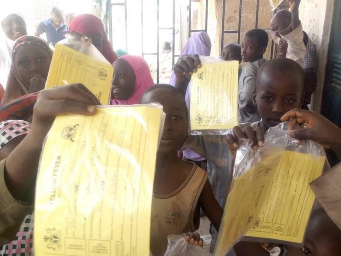 Children showing their yellow fever vaccination cards in Tsafe Central ward, Tsafe LGA after getting vaccinated. The transparent bags were introduced to encourage safe keeping of their cards