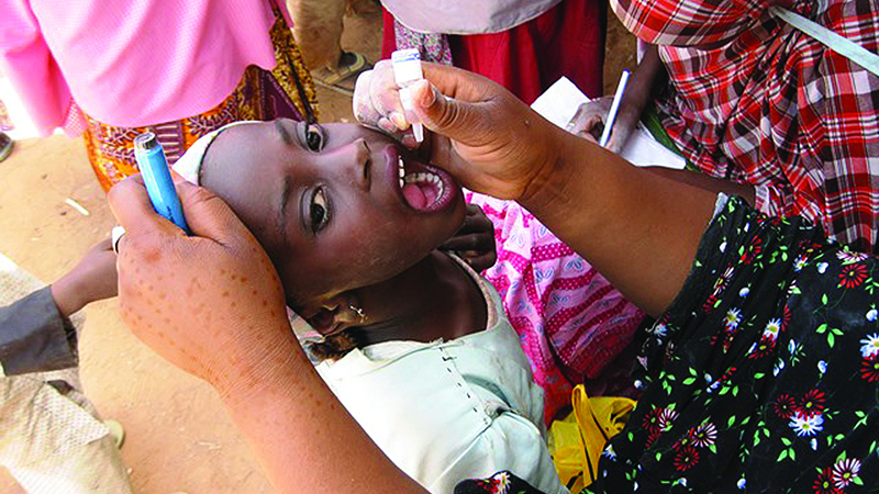 A child receives polio drops during a vaccination campaign in Katsina State, Nigeria, 2014.   Credit: CDC STOP Program, A.J. Williams
