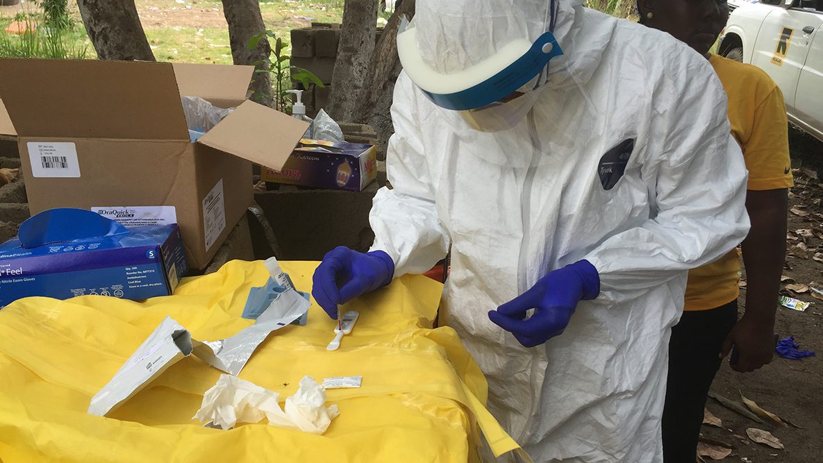 Disease detectives conducting testing out in the field during the 2014 Ebola outbreak in Liberia.