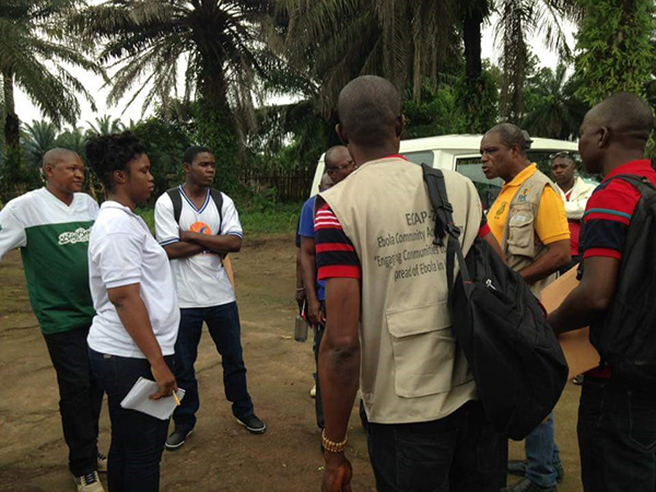 A mentor provides technical oversight for disease detectives trainees during a measles