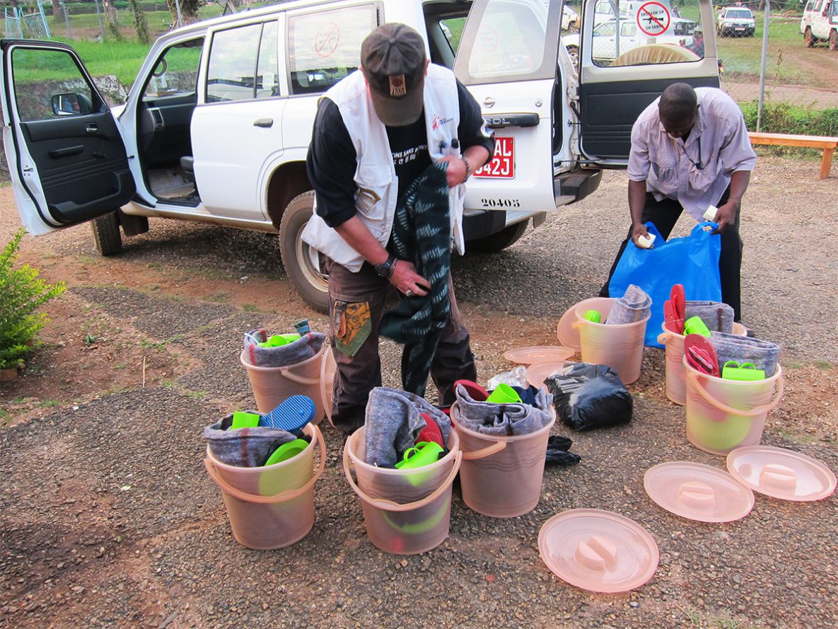 A member of the organization, Doctors Without Borders, i.e., Médecins Sans Frontières (MSF) (Lt) and a Ugandan health worker were preparing kits for Ebola survivor patients to take home when they were discharged from the Hospital.