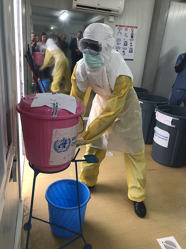 A member of the International Medical Corps washing their hands after handling a “suspect” Ebola patient in an Ebola isolation facility during the simulation exercise. Photo by Aimee Summers