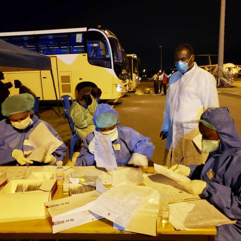 CDC Cameroon Associate Director for Program and Science, Dr. Clement Ndongmo, observing COVID-19 testing procedures for arriving passengers at Nsimalen International Airport in Yaoundé. Photo by Cameroon Ministry of Health.