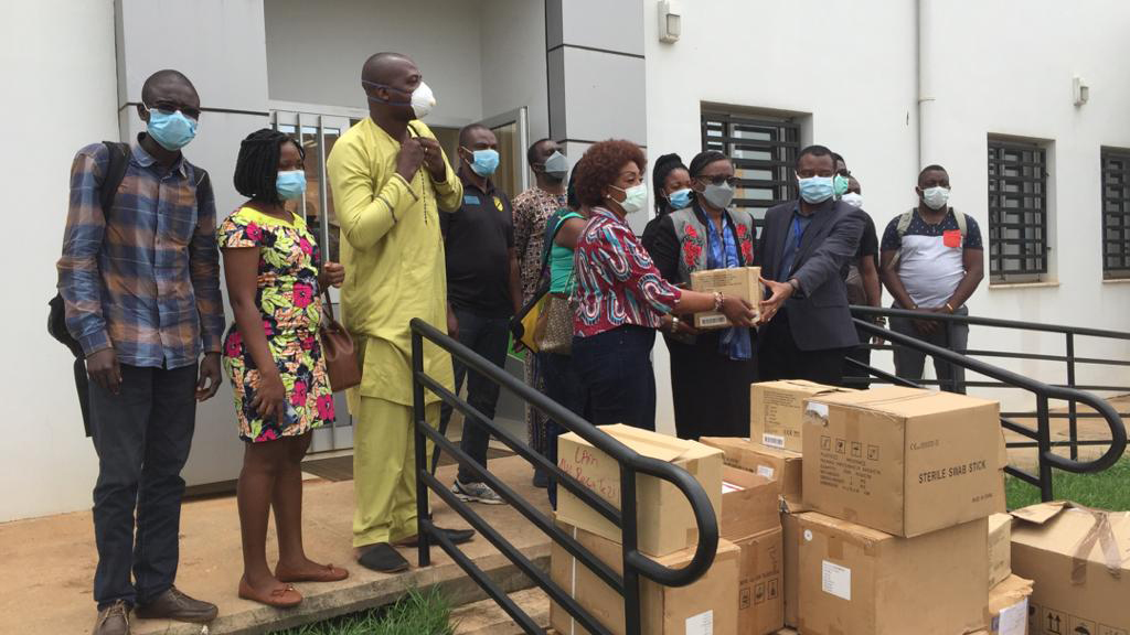 CDC Cameroon Care and Treatment Branch Chief, Dr. Judith Shang, and CDC Cameroon Associate Director for Program and Science, Dr. Clement Ndongmo, donating laboratory supplies to the National Public Health Laboratory. Photo by Gordon Okpu.