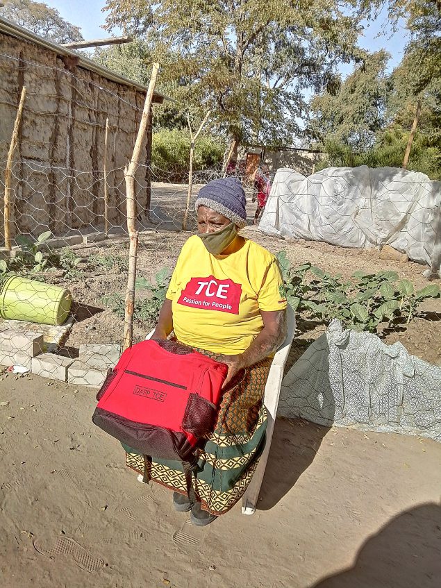 A community member attends a community adherence group supported by Development Aid from People to People