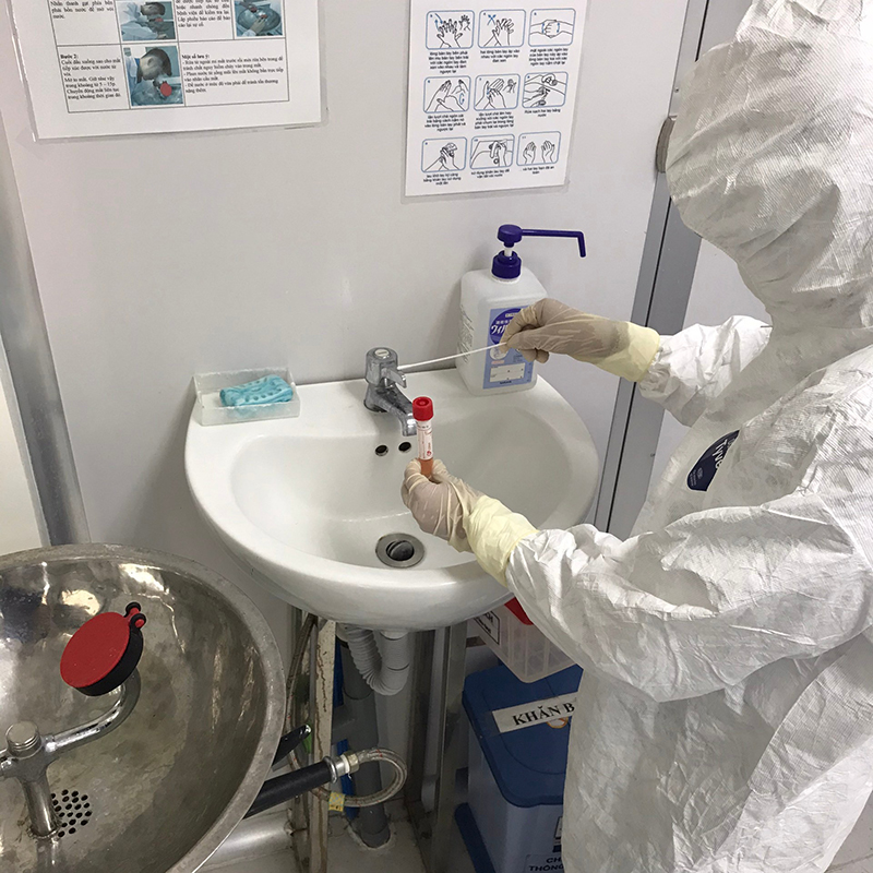 Taking a sample from a faucet handle at the Pasteur Institute of Nha Trang (PINT) laboratory. Photo Credit: Mr. Truong Tien Dat.