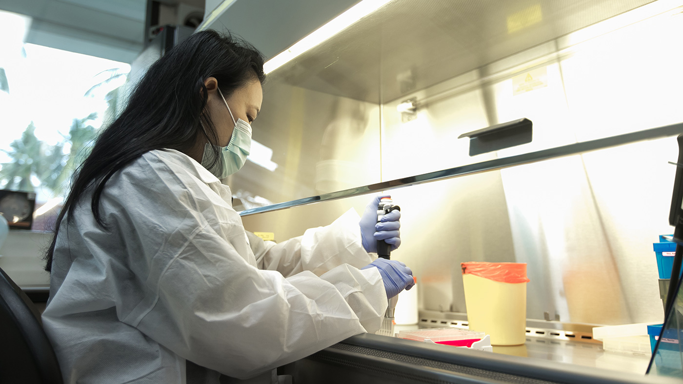 A CDC Thailand Laboratory staff member tests a sample for the virus that causes COVID-19.