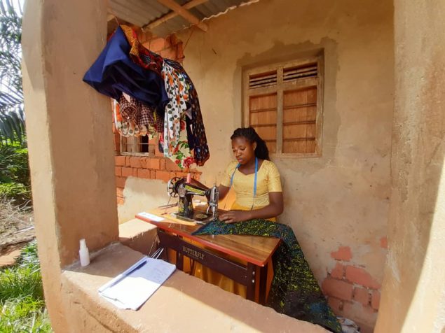A DREAMS program participant uses her sewing machine, which is one of the income generating opportunities