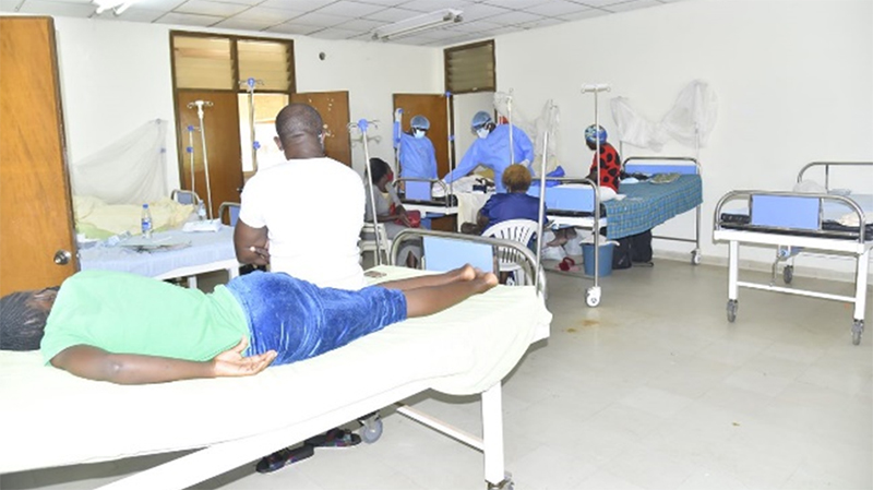 Two doctors check on patients staying at the COVID-19 treatment facility