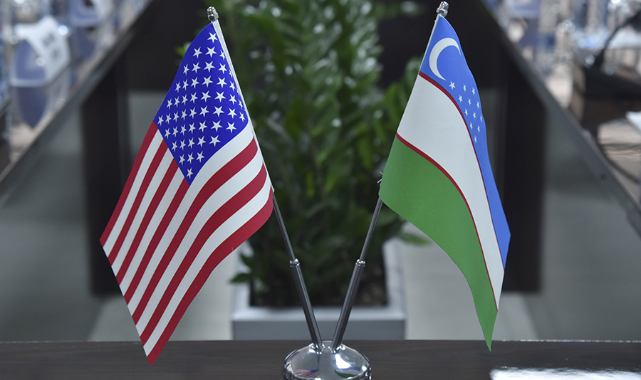 Flags of the United States of America and the Republic of Uzbekistan adorned a meeting table