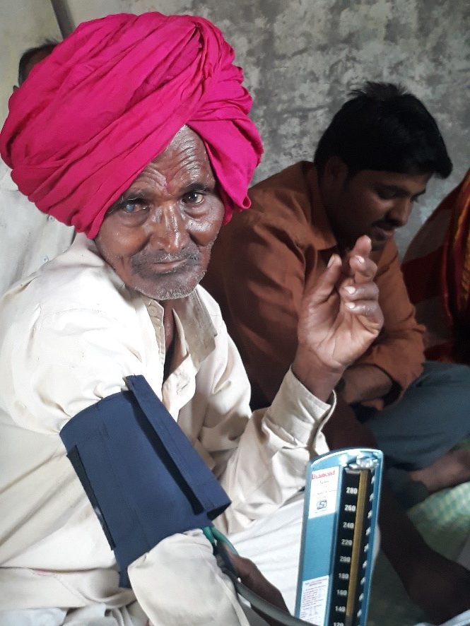 An elderly man with cataracts is screened for hypertension for the first time during May Measurement Month 2017. Research suggests a possible link between untreated hypertension and cataracts. Photo credit: Dr. Arun More