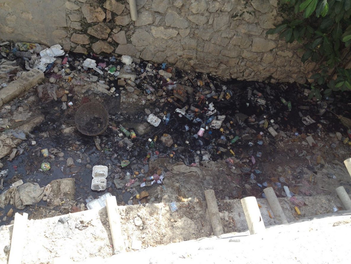 An example of poor fecal sludge management with septic tanks overflowing into drainage canals in the heart of Port-au-Prince, Haiti (Photo courtesy of Andrea Martinsen, CDC)