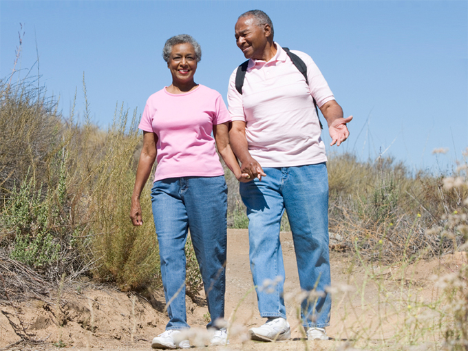 Elderly couple walking on the beach