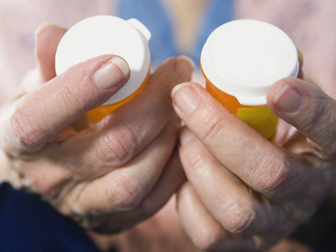 View of a senior woman holding medicines