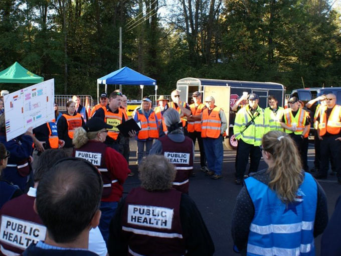 citizens and police gathered in a parking lot