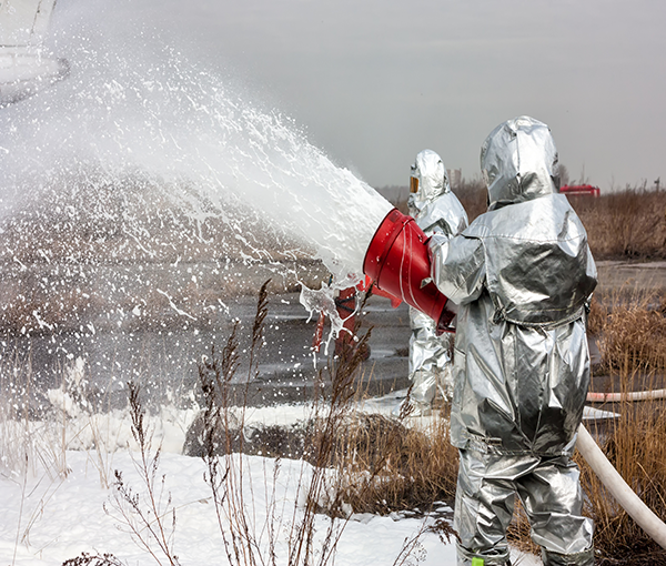 man in sterile suit spraying water