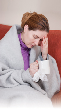 woman sick and drinking tea