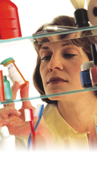 woman looking in medicine cabinet