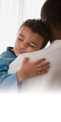 sick child held over shoulder of caregiver