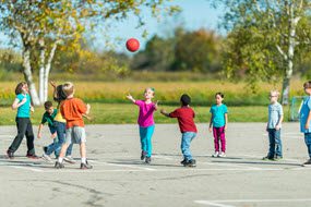 Wisconsin_small Kids on a playground with a ball.