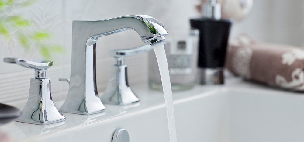 Water coming out of a bathroom faucet.