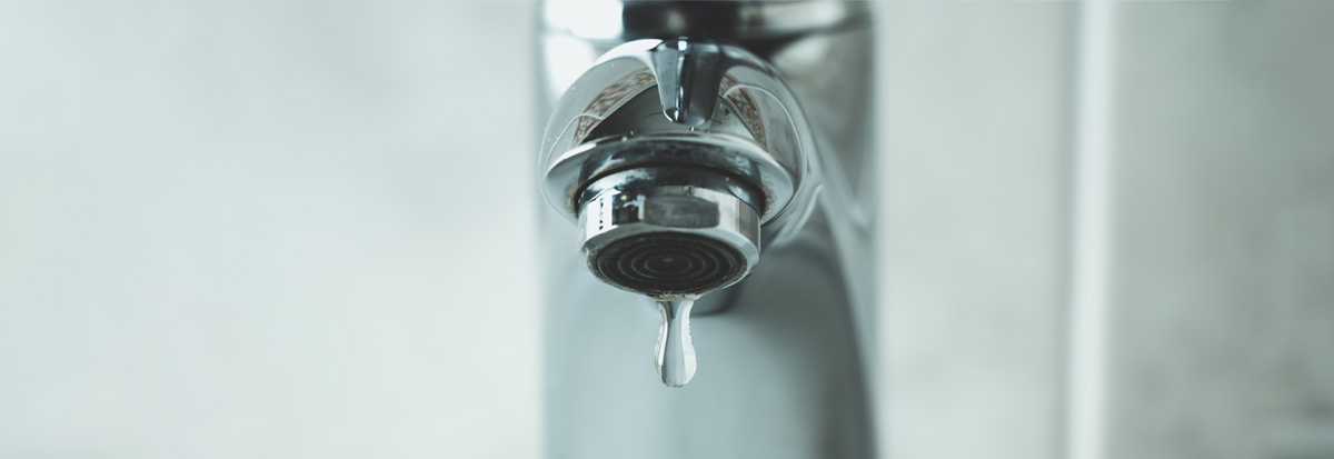 Image of a sink faucet dripping water