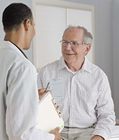 doctor with seated elderly man