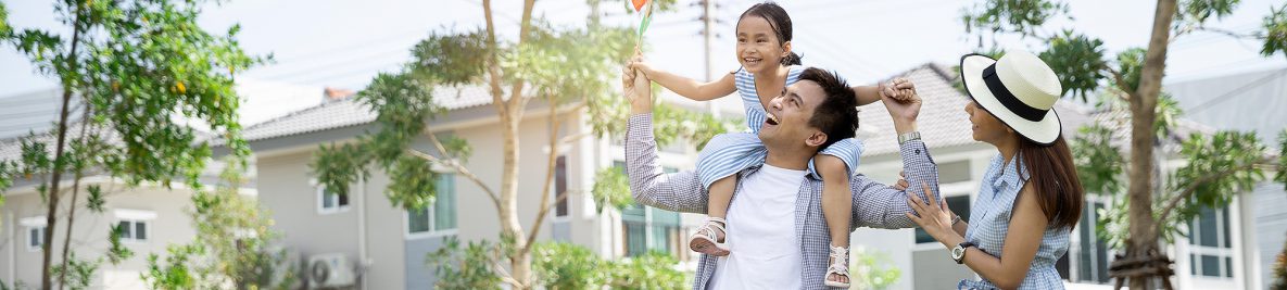 Happy, young Asian family, daughter on dad's shoulders, enjoying positive well-being.