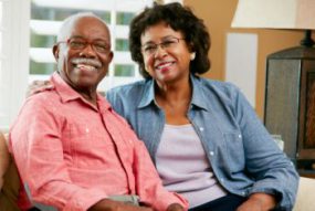 older black couple sitting inside