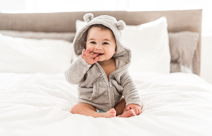 Cute baby in a bear sleeper outfit