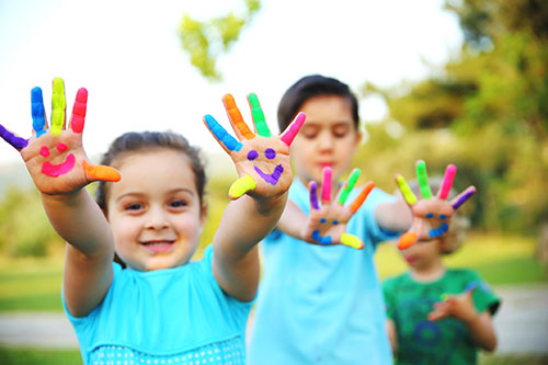 Young children playing with finger paint