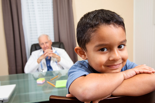 Boy in a doctor's office facing backwards in his chair